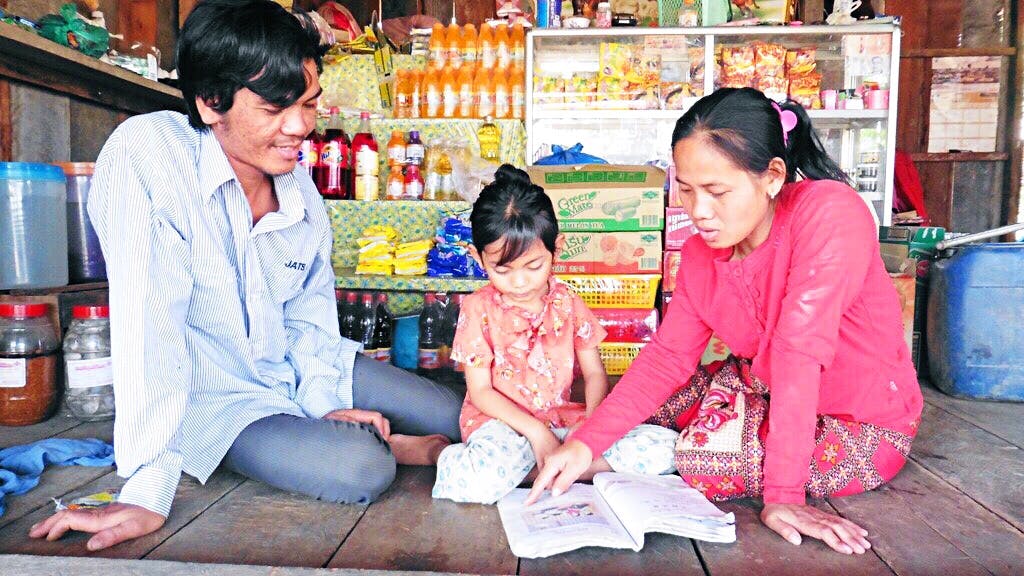 Photo of family reading to improve literacy