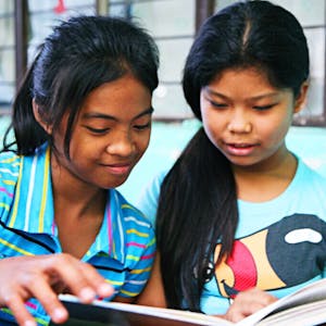 Girls reading who know literacy will help them succeed