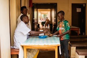 Boy in Burundi receives deworming tablet