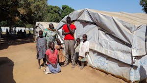 South Sudan family outside of tent