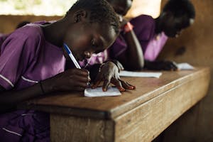 Child in Uganda at school desk