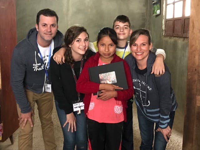 The Schuler family met their sponsored child, Margarita, who treasured the photo book they gave her.