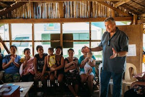 Gary Edmonds stands and talks to a group of local leaders in the Philippines