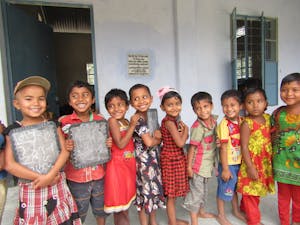 Preschoolers standing outside of their school in Bangladesh.