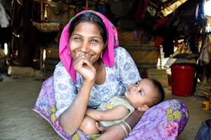 A smiling mother in Bangladesh with her baby.