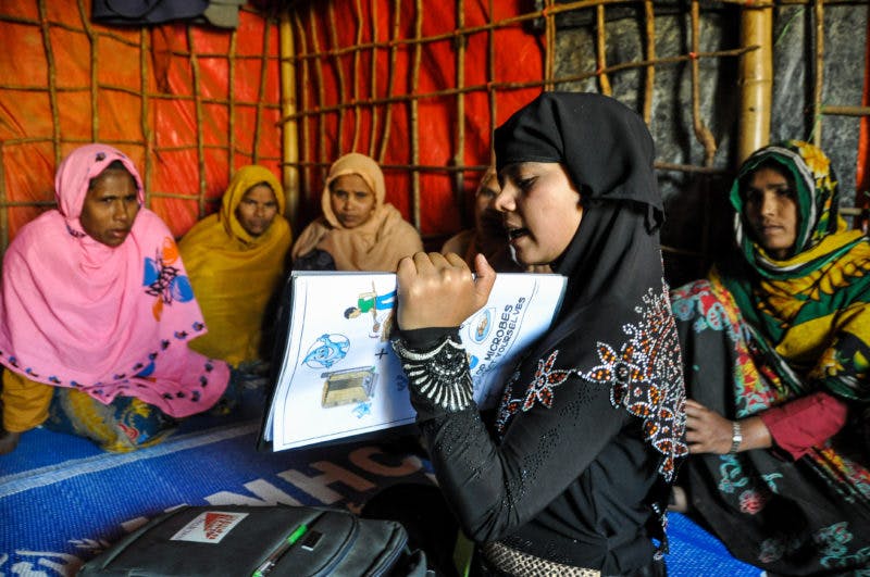 woman teaching other women using health chart
