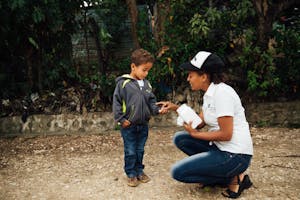 Young boy in the DR receives vitamin, a new item in the FH gift catalog