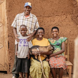 A family in Burundi holding a goat