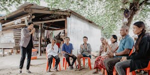 Disabled members meet under a tree to discuss their grocery coop in Cambodia, built in partnership with FH, provides hope after Khmer Rouge