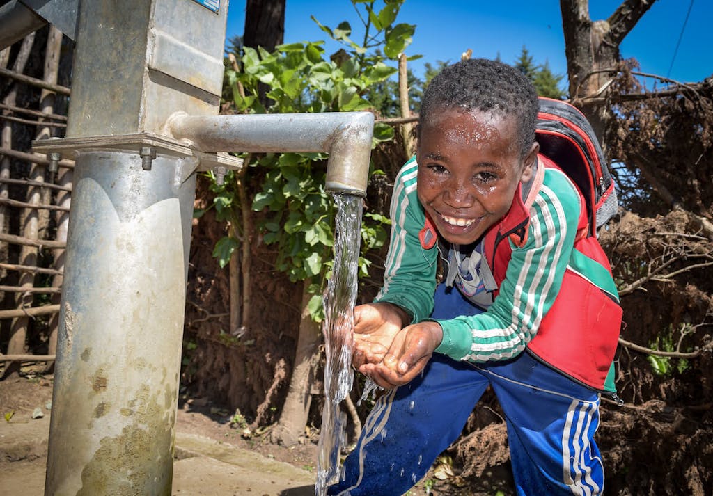 boy-at-the-water-hand-pump