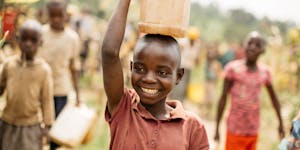 Child in Burundi Carrying Water in a jerrycan