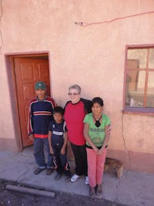 Marcella, an FH child sponsor and staff member, poses for a photo with her sponsored child Raul and his family in Bolivia.