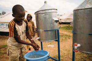 A young boy in Rwanda practices good handwashing habits!