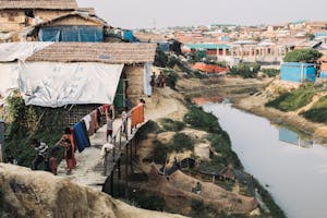 Landscape with tents and river in Rohingya refugee camp, where FH is working to prevent coronavirus in Cox's Bazar