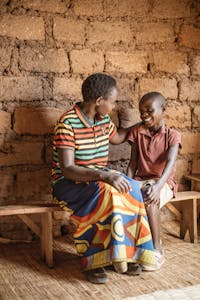 Burundia boy on a bench with his mother