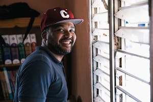Dominican humanitarian staff worker smiles by the window