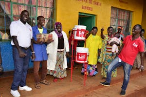 happy people receiving hand washing stations to fight covid-19