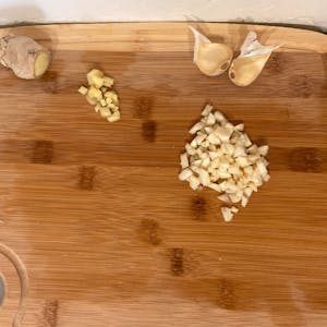 chopped ginger and garlic on a cutting board