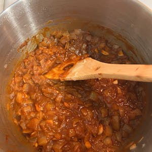 pot of onions, garlic, ginger, and berbere paste mixed together on the stove