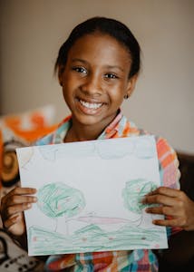 Dominican girl holding a drawing.