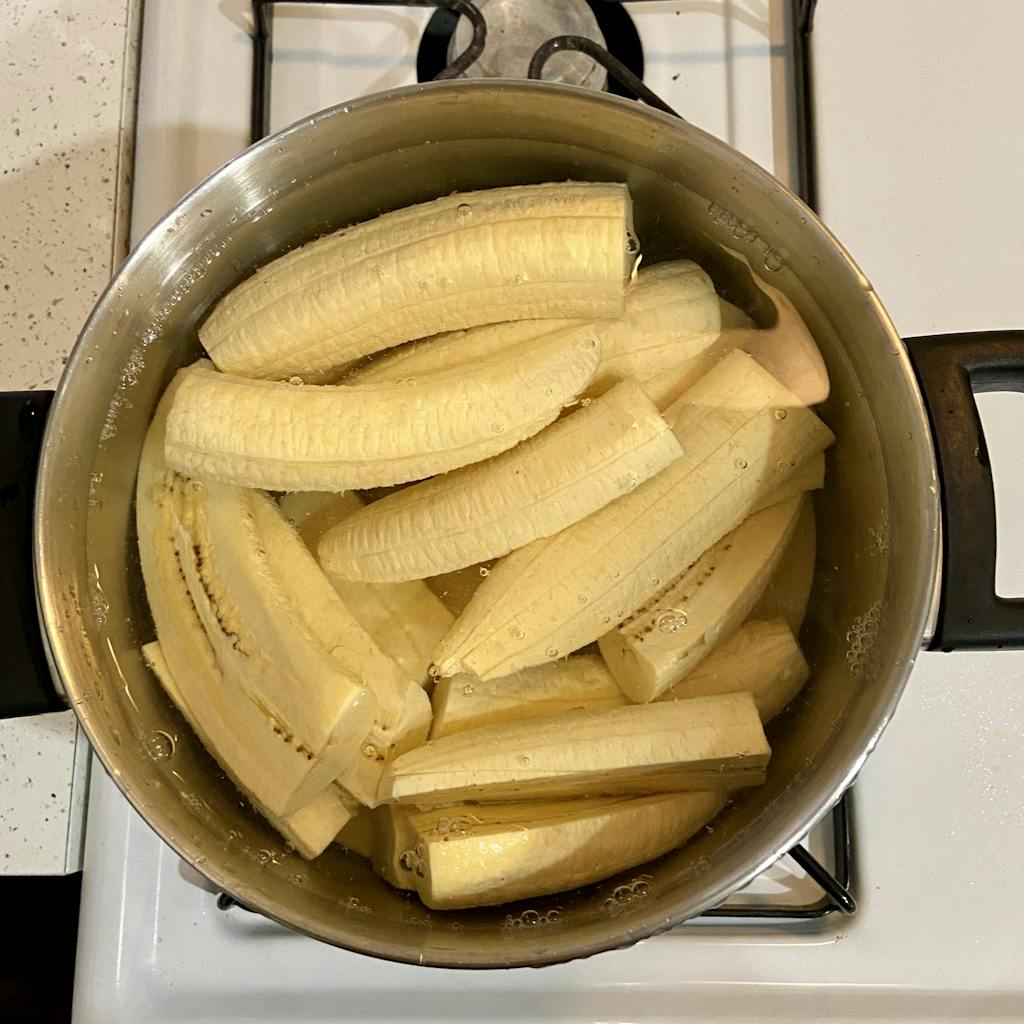 plantains in a pot of water on the stove