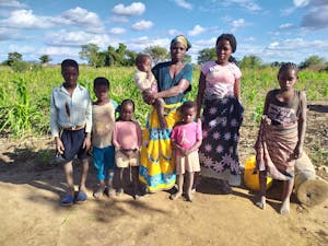 Rosita and her children pose for a photo in front of their fields.