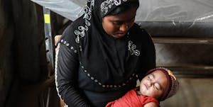Rohingya mother holding her baby.