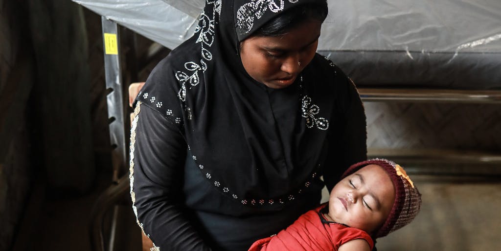 Rohingya mother holding her baby.