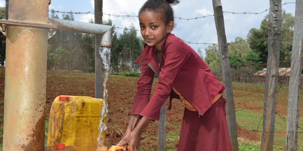 Ethiopian child has access to clean water using a hand dug well.