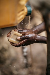a child washing their hands with a bar of soap