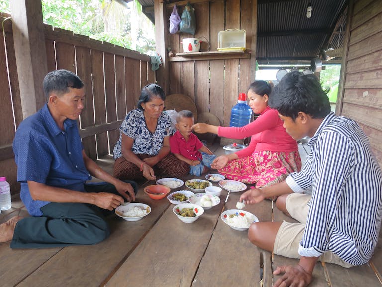 Family from Cambodia eating