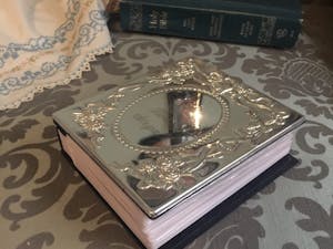 Silver wedding album with Bible in the background