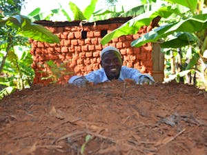 a man next to his compost