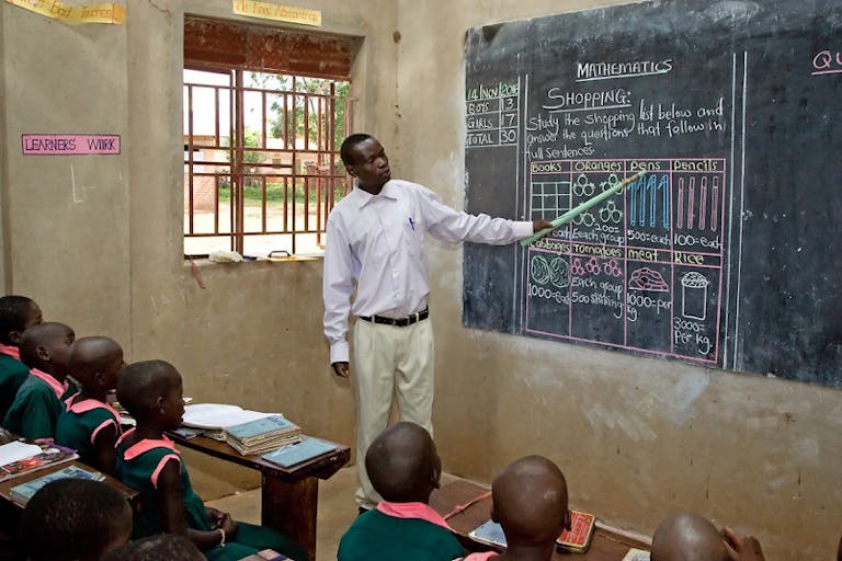 Teacher in Uganda at the blackboard