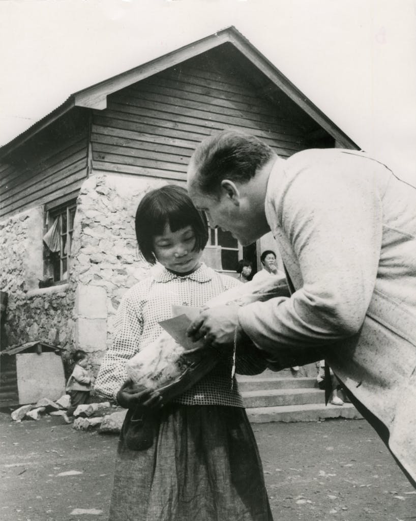 Dr. Ward sharing Bible tract with a little girl