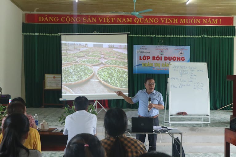 Man teaching in classroom about tea production