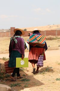 Bolivian women with food boxes and emergency kits
