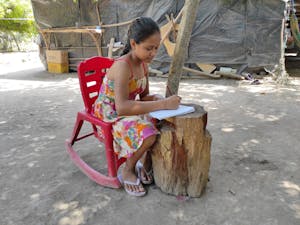 14-year-old Kency is now able to focus on her homework because Food for the Hungry Child Sponsorship helped her family rebuild after from two back-to-back hurricanes.