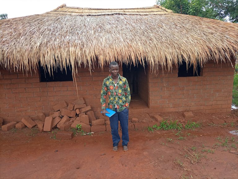 A young participant in the Mutambala Youth Group became secretary of the group and completed FH livelihood training. Soon, he opened a tiny store in the community and, with his proceeds, has built this new home, where he now lives.