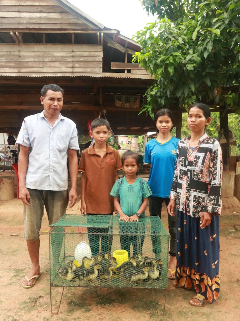 ducks-with-cambodian-family-standing-behind