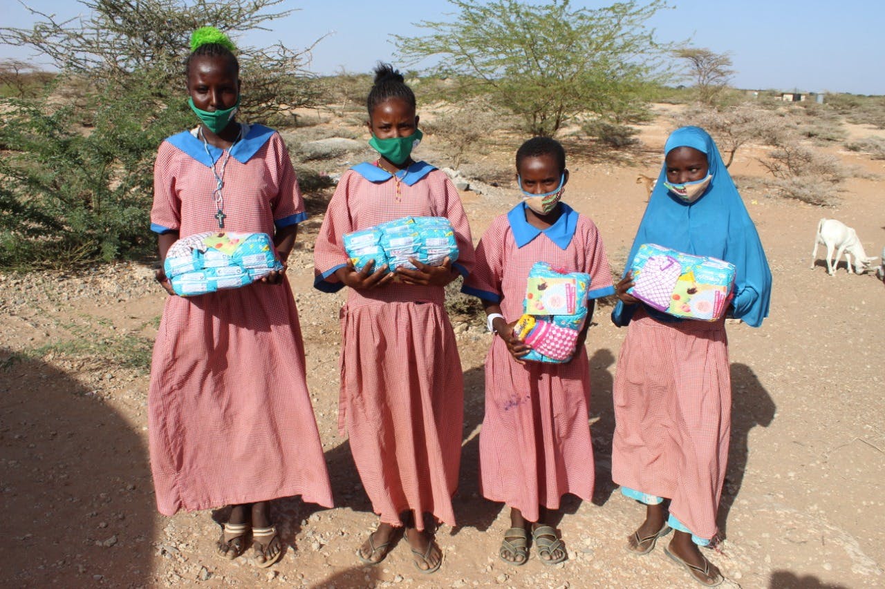Young school girls holding their Dignity kits.
