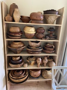 bowls and other items crafted by woodturning on a shelf