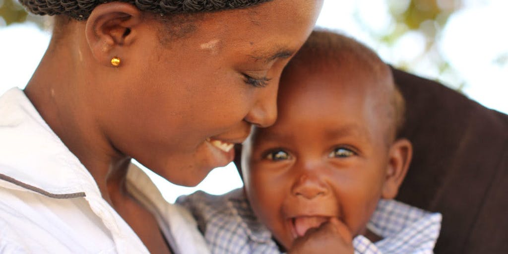 A smiling mother and her baby