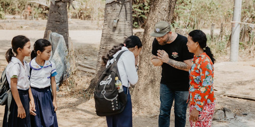 An American staff member greeting his sponsored child in Cambodia