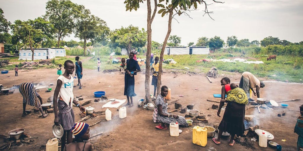 Scene of some community members under a tree in Uganda