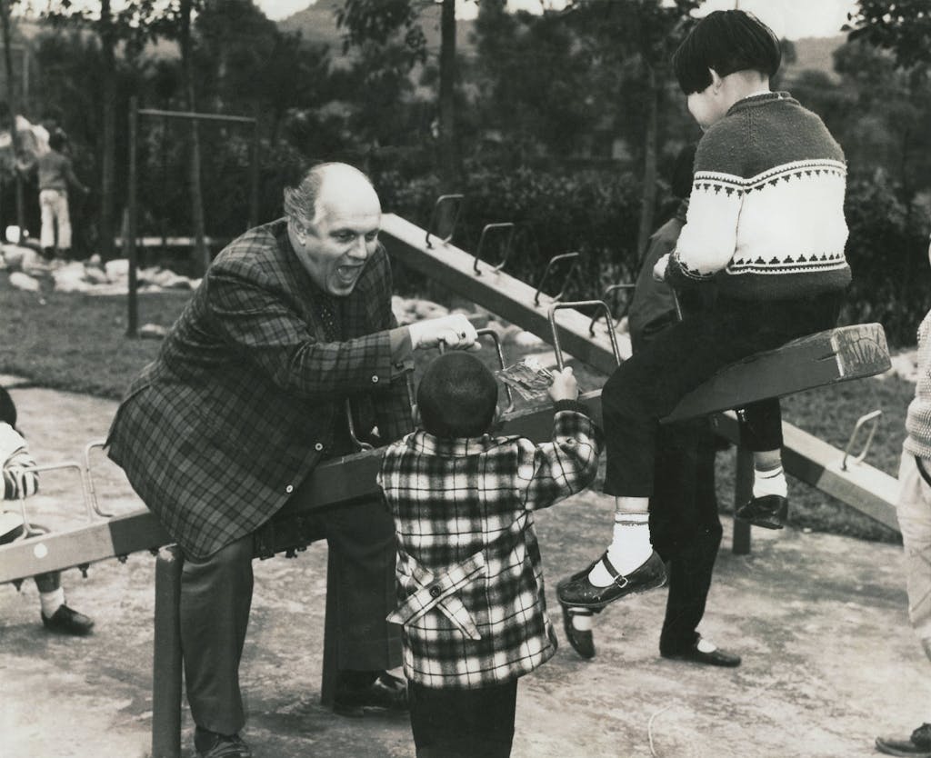 Dr. Ward playing with child on see saw