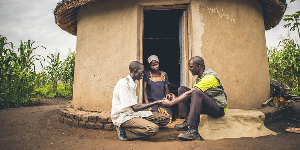 FH Staff Member Praying with a Family