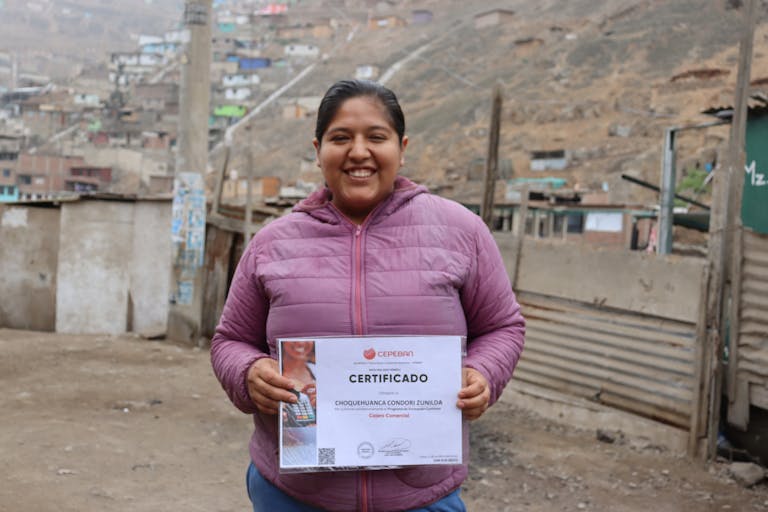 Zunilda with her certificate of completion