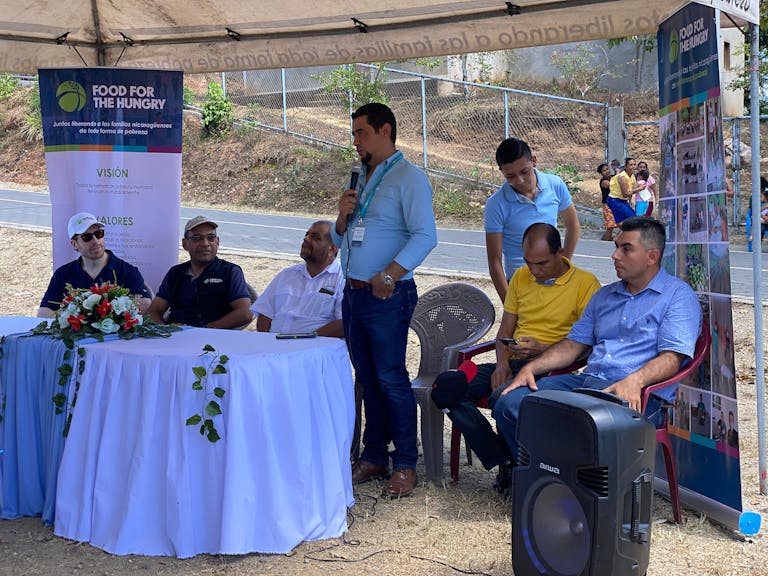 Franklin participating in the water project inauguration. FH team member offers words of gratitude.