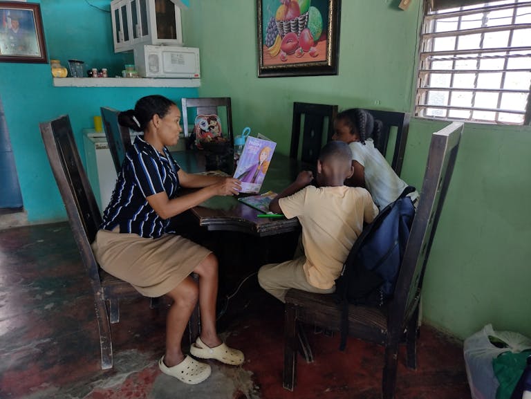 Dulce uses the techniques she learned in parent school to teach her children to read.